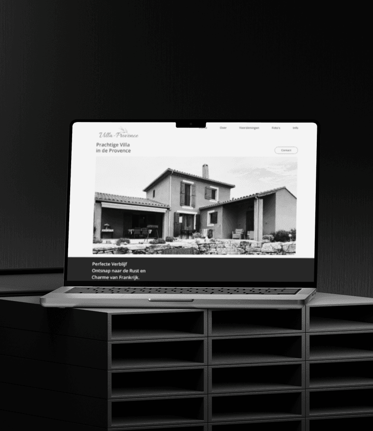 MacBook displaying the SenneVdc web design project, placed on a shelf